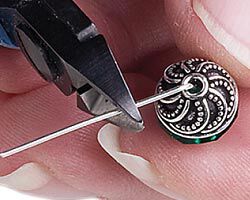 Wire cutters trimming loose end of bent wire